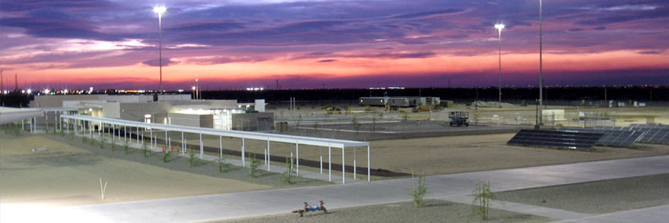 A large building featuring a prominent solar panel installed on its roof, emphasizing sustainable energy use.