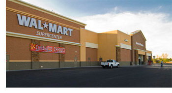 A Walmart Supercenter located in a vast desert, highlighting its contrast against the arid environment and clear skies.